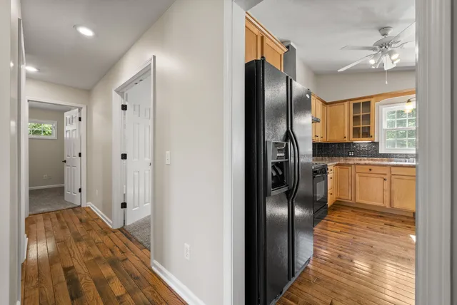 a spacious bedroom with a bed and a ceiling fan