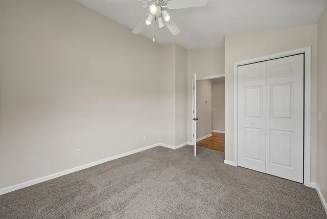 a front view of a house with a yard and trees