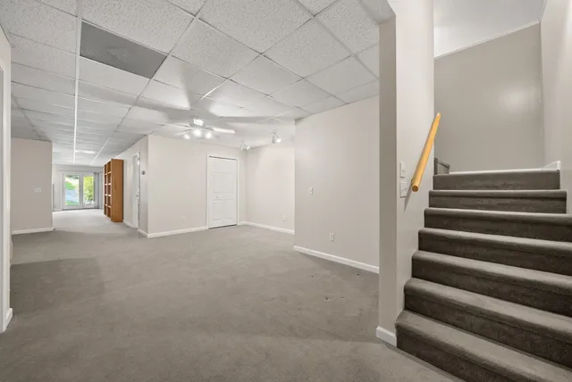an aerial view of a house with a yard and lake view