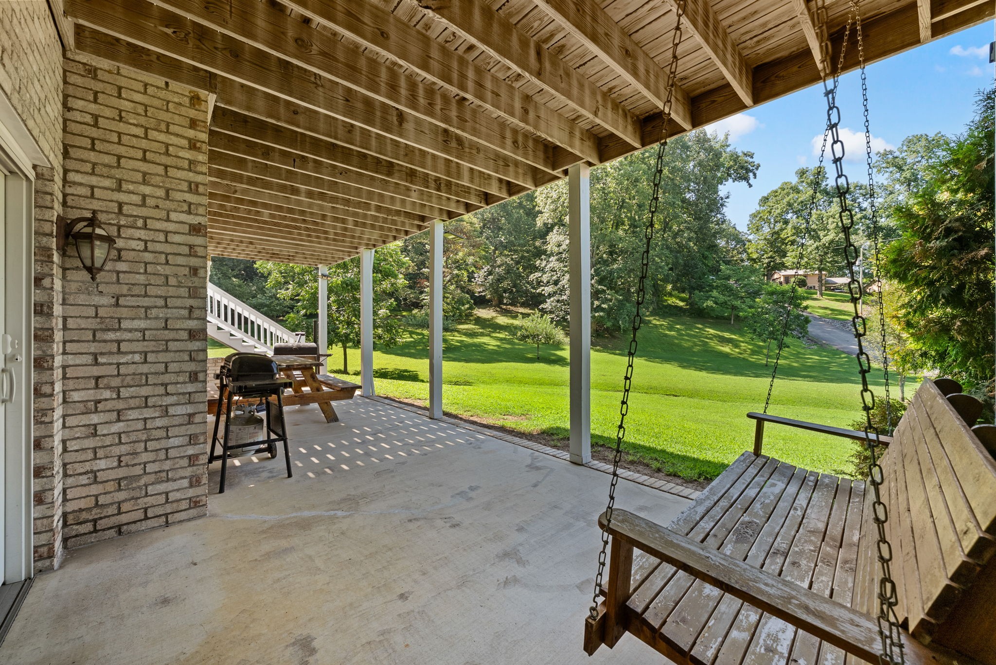 202 Partridge Point Cadiz, KY 42211 - Photo 53 of 100 a view of a deck with a table and chairs under an umbrella with a small yard