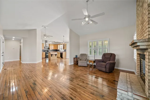 a view of an empty room with a kitchen