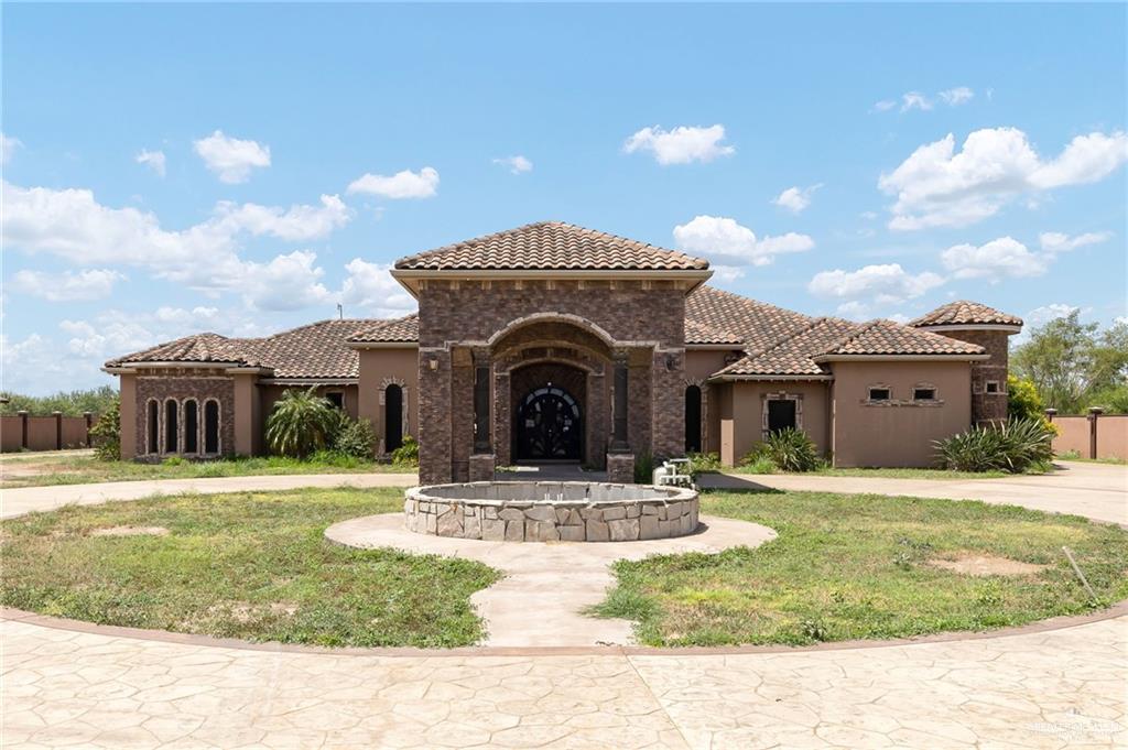 22111 Uresti Road Edinburg, TX 78542 - Photo 4 of 38 Mediterranean-inspired exterior with a tile roof and stucco finish