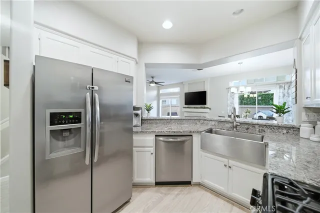 a kitchen with a sink stainless steel appliances and cabinets