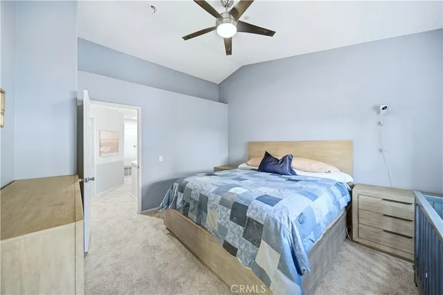 a bedroom with a bed and a ceiling fan