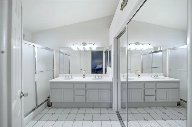 a bathroom with a sink double vanity and a mirror