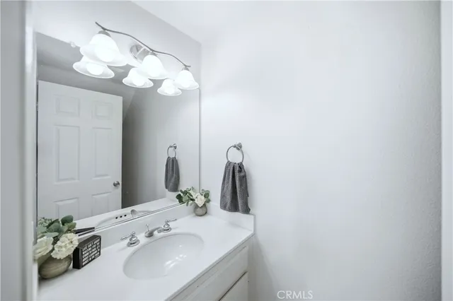 a bathroom with a sink vanity and a mirror