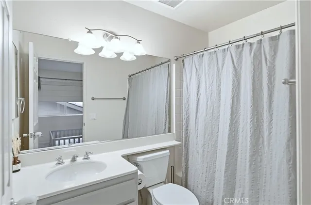 a bathroom with a sink a mirror and a toilet