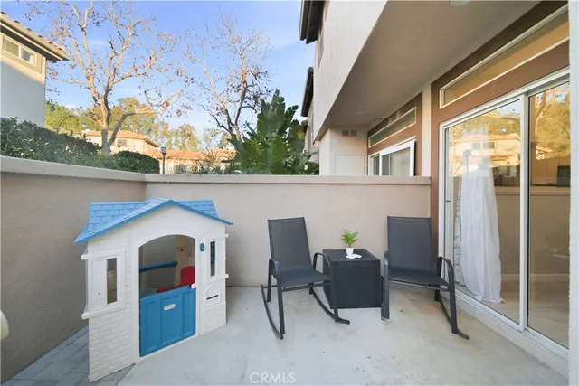 a view of balcony with furniture and potted plants