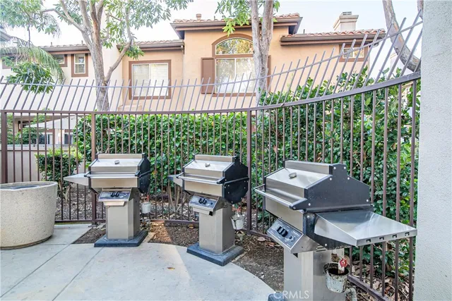 a view of a patio with table and chairs and potted plants