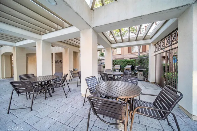 a view of a dining room with furniture a chandelier and wooden floor