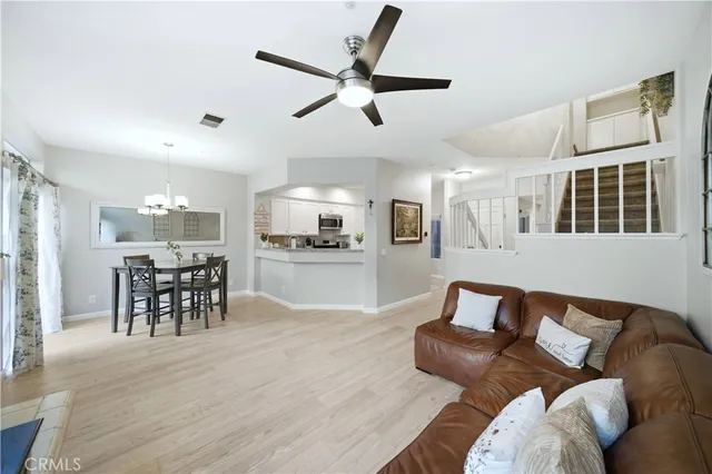 a living room with furniture and kitchen view