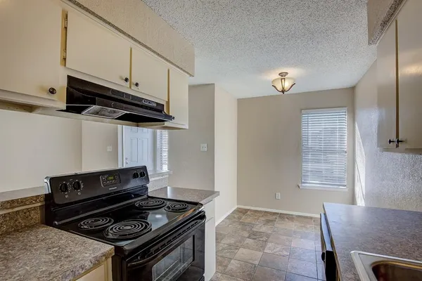 a kitchen with a stove and a microwave