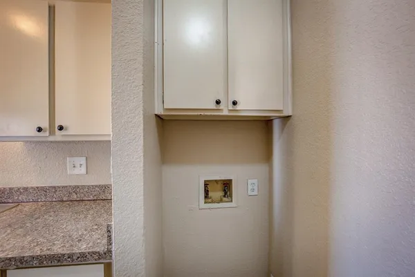 a view of a room with a ceiling fan and window