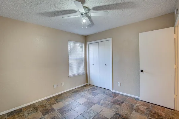 a bathroom with a sink granite tub toilet and a mirror