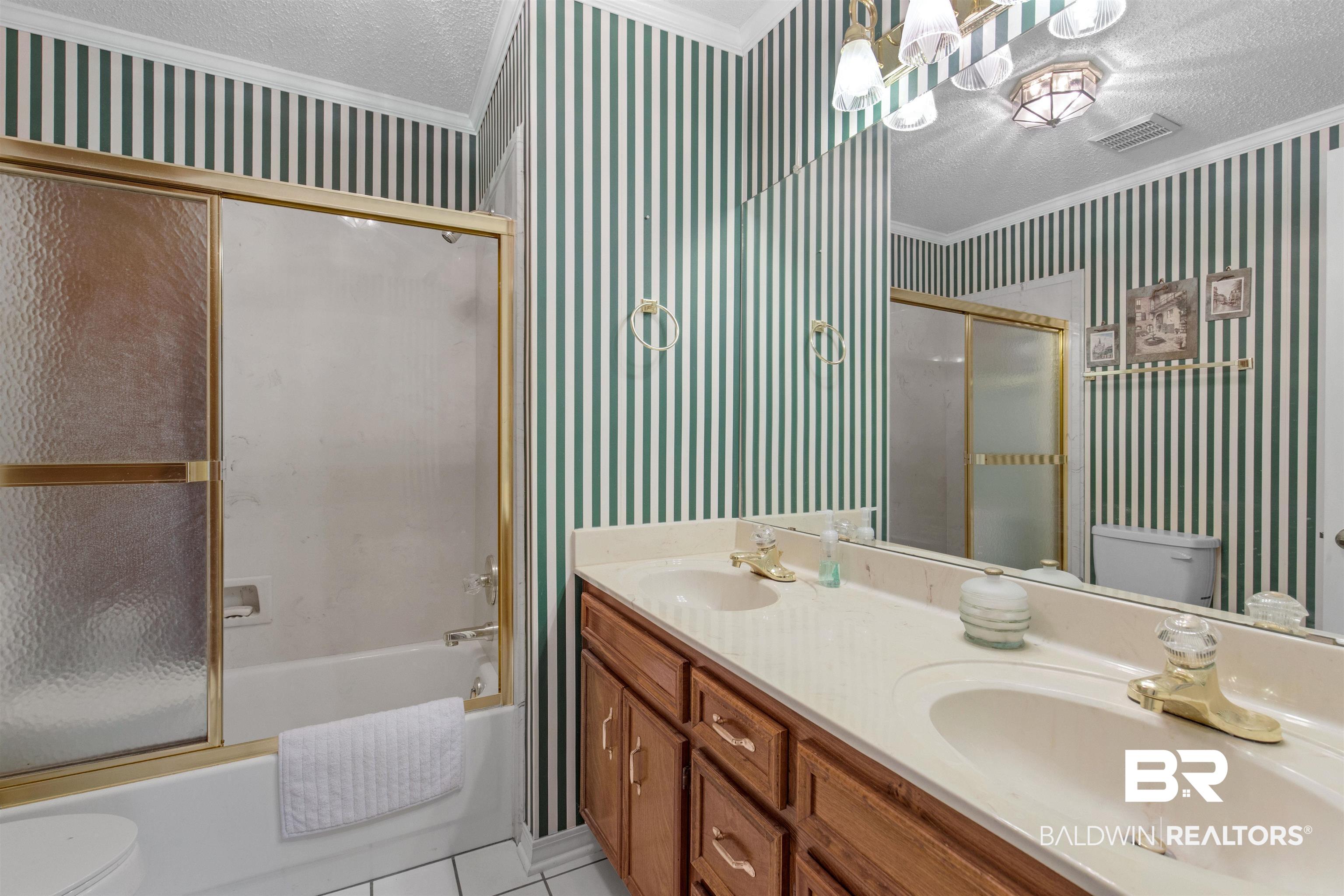 7225 Smithfield Road East Mobile, AL 36695 - Photo 11 of 27 Full bathroom featuring wallpapered walls, a textured ceiling, toilet, and a sink