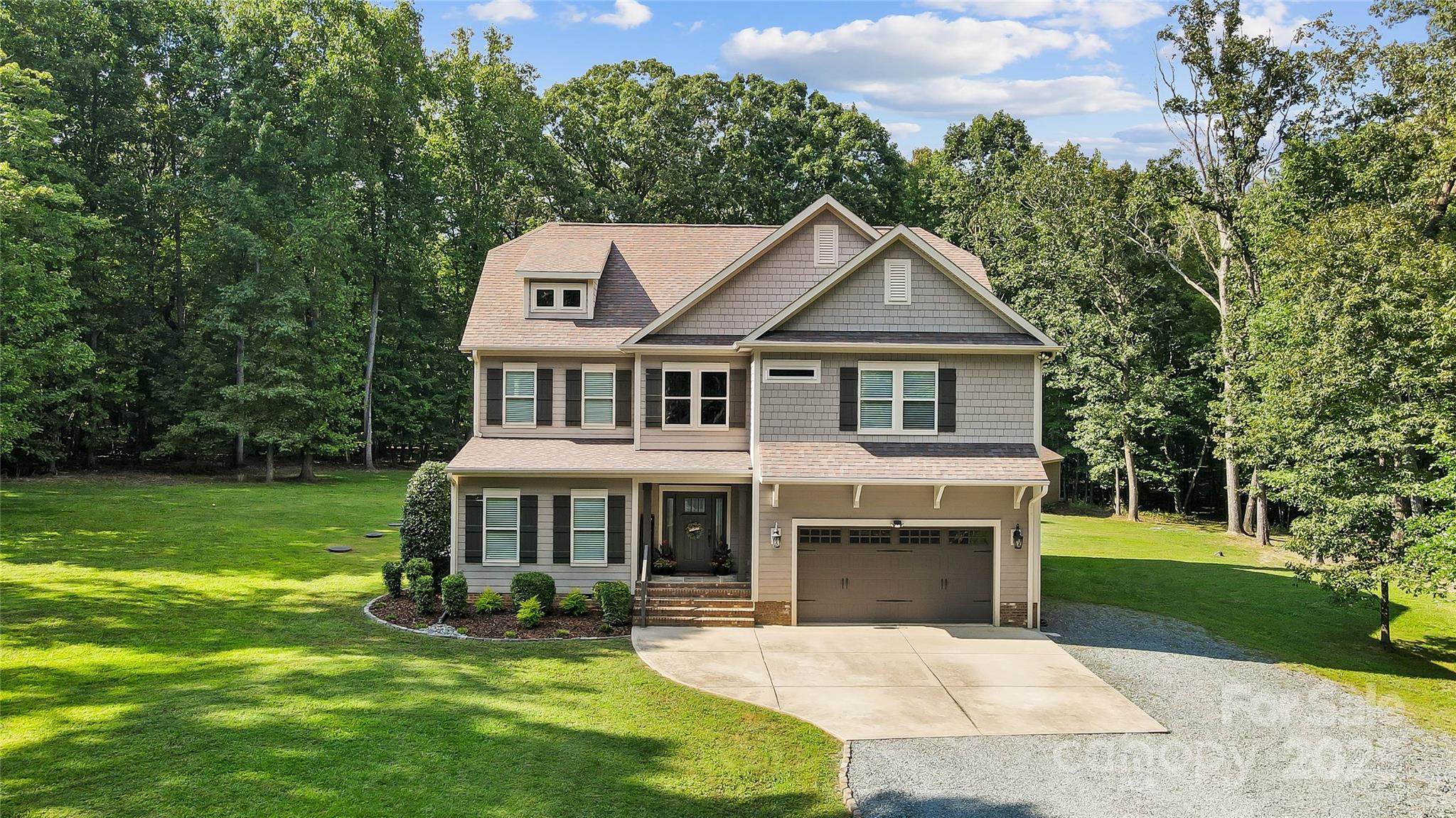 7219 Indian Trail Fairview Road Indian Trail, NC 28079 - Photo 13 of 48 a front view of a house with a yard table and chairs