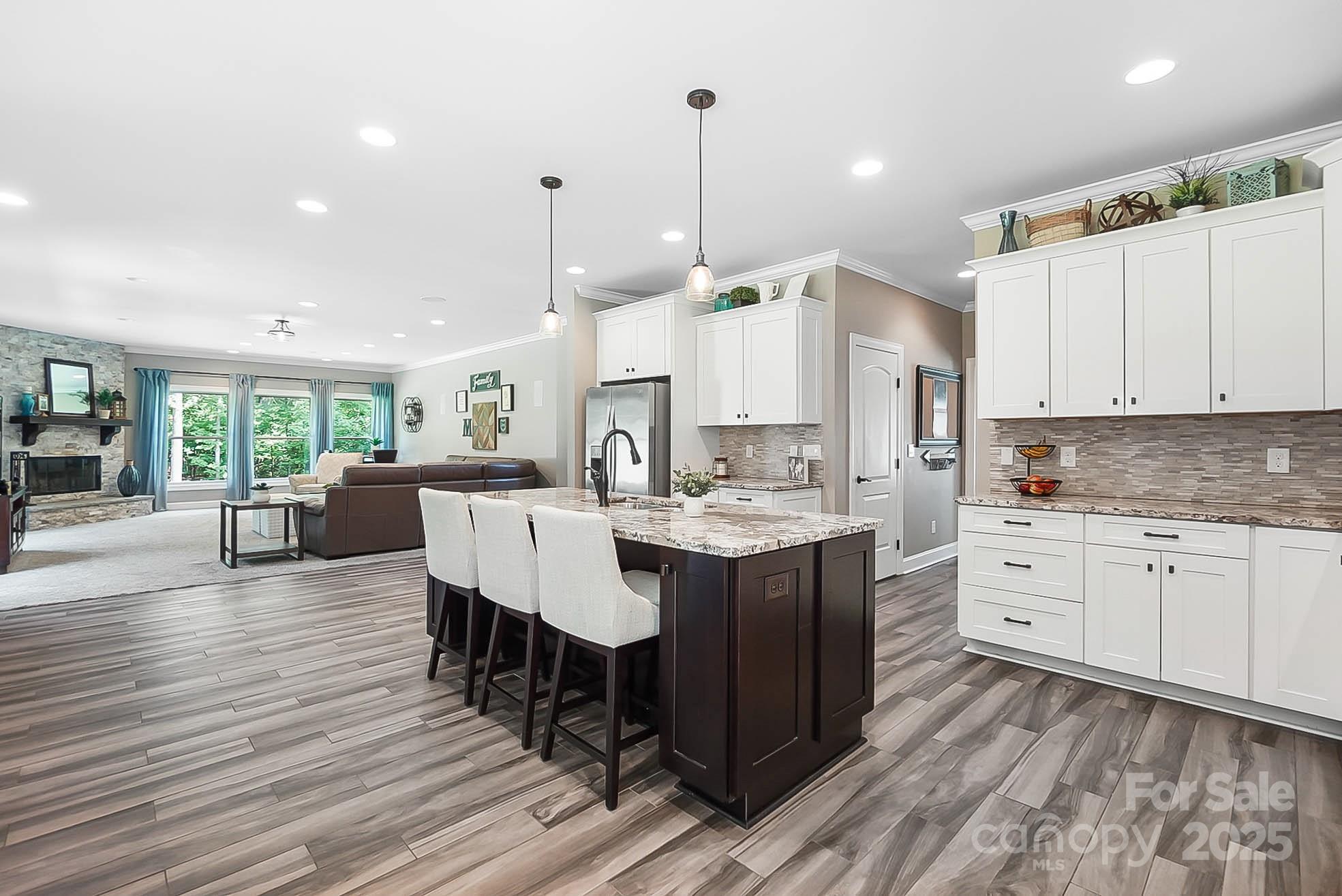 7219 Indian Trail Fairview Road Indian Trail, NC 28079 - Photo 19 of 48 a large kitchen with kitchen island a island a sink a stove and a center island