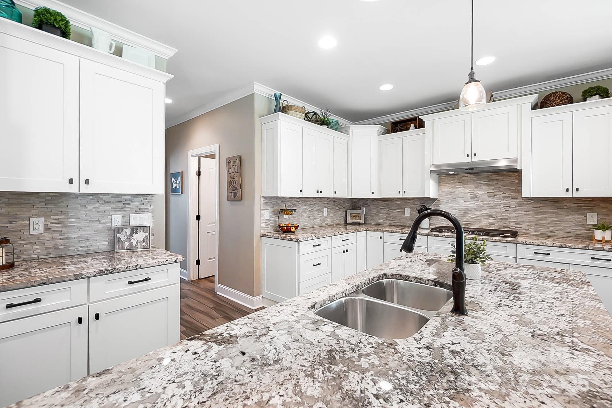7219 Indian Trail Fairview Road Indian Trail, NC 28079 - Photo 21 of 48 a kitchen with kitchen island granite countertop a sink stainless steel appliances and cabinets
