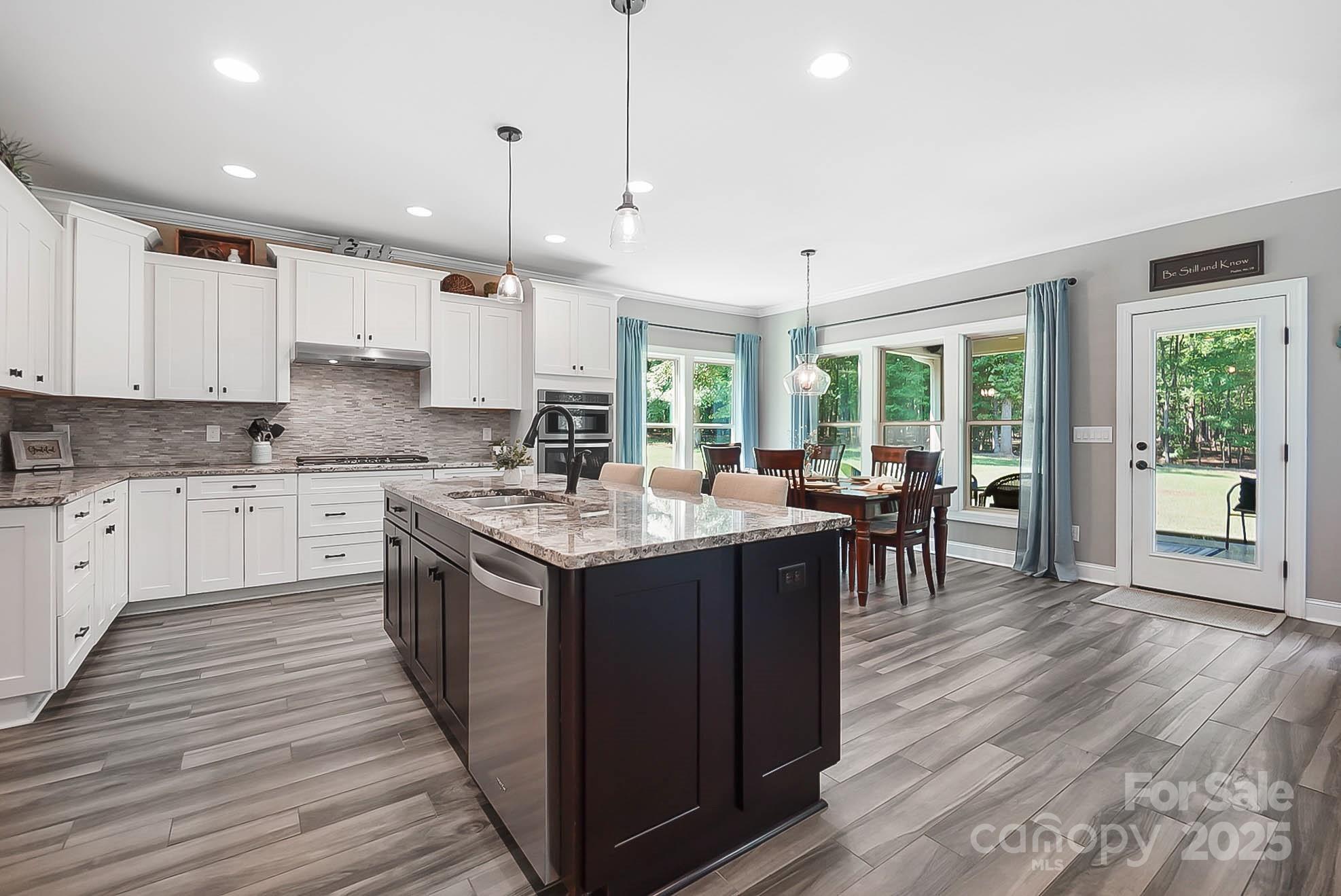 7219 Indian Trail Fairview Road Indian Trail, NC 28079 - Photo 22 of 48 a kitchen with a stove sink and cabinets