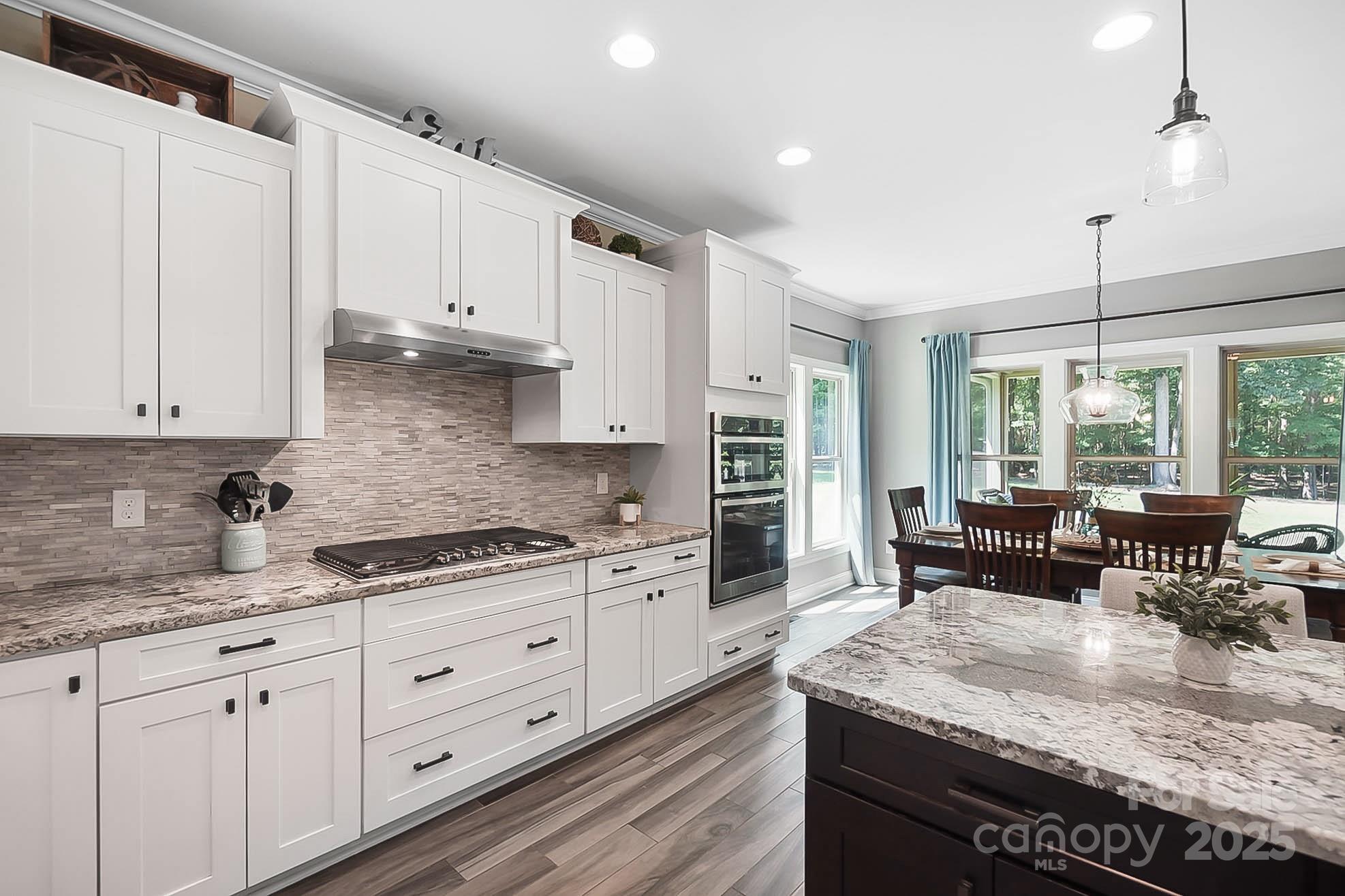 7219 Indian Trail Fairview Road Indian Trail, NC 28079 - Photo 24 of 48 a kitchen with granite countertop white cabinets and white appliances