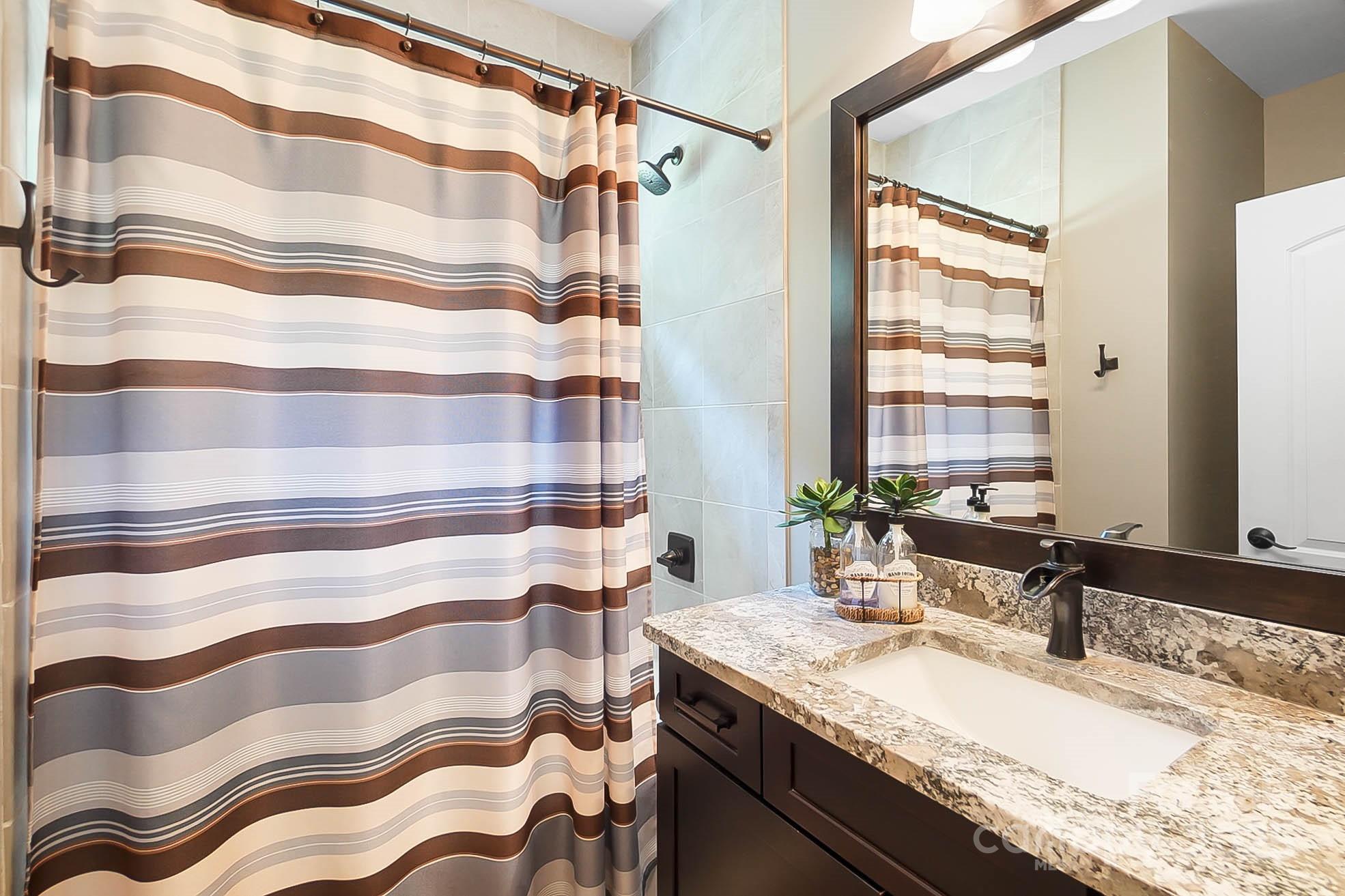 7219 Indian Trail Fairview Road Indian Trail, NC 28079 - Photo 28 of 48 a bathroom with a granite countertop sink and a mirror