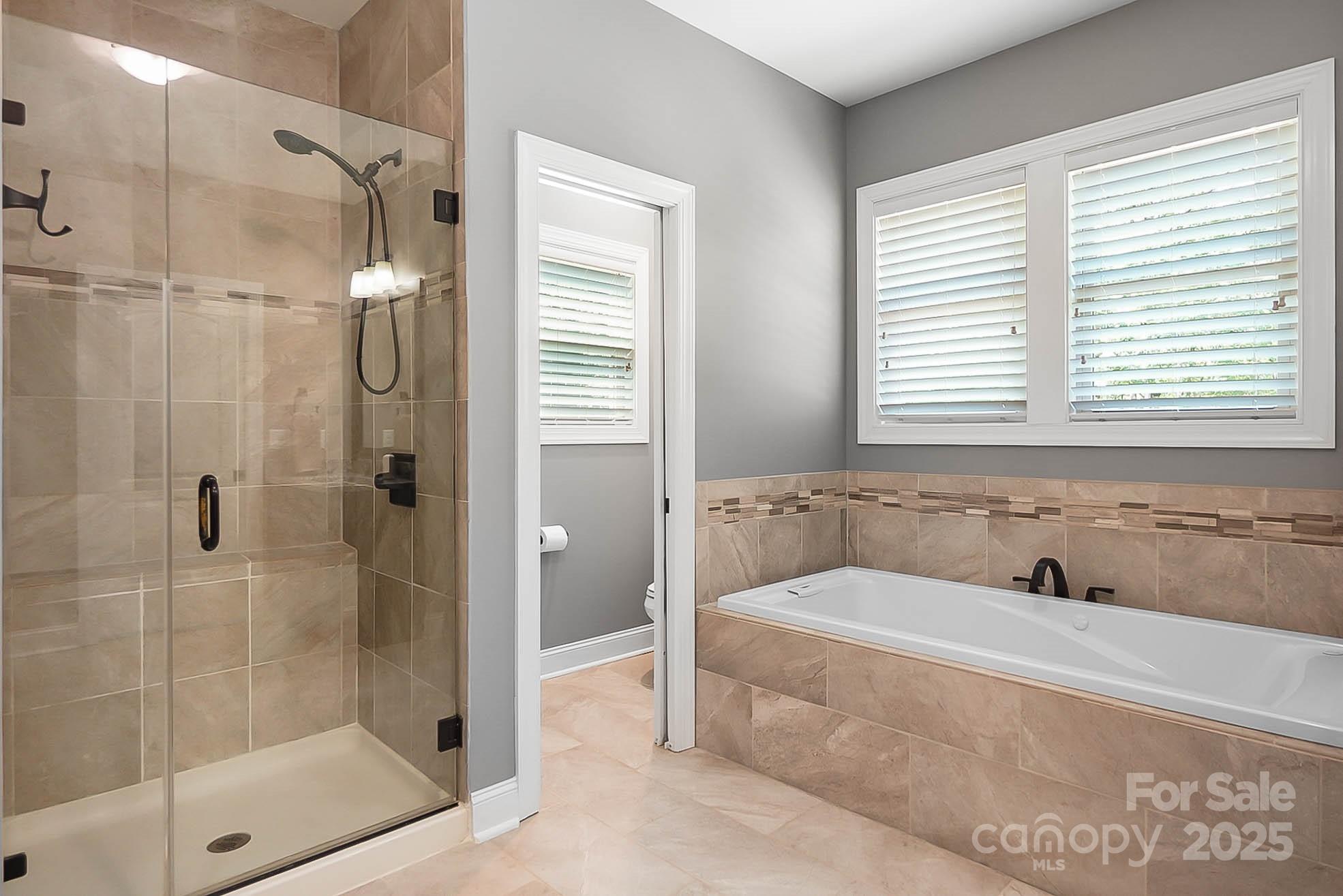 7219 Indian Trail Fairview Road Indian Trail, NC 28079 - Photo 34 of 48 a bathroom with a tub shower and sink