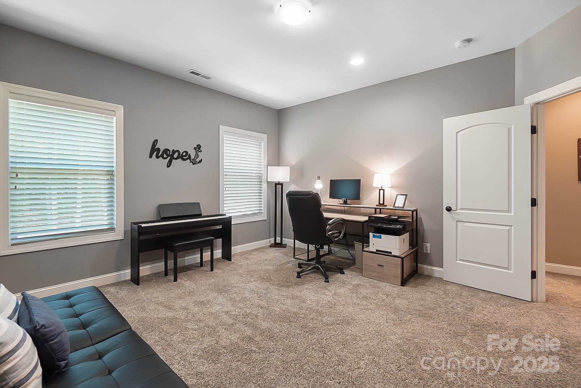 7219 Indian Trail Fairview Road Indian Trail, NC 28079 - Photo 36 of 48 a view of a workspace with furniture and a window