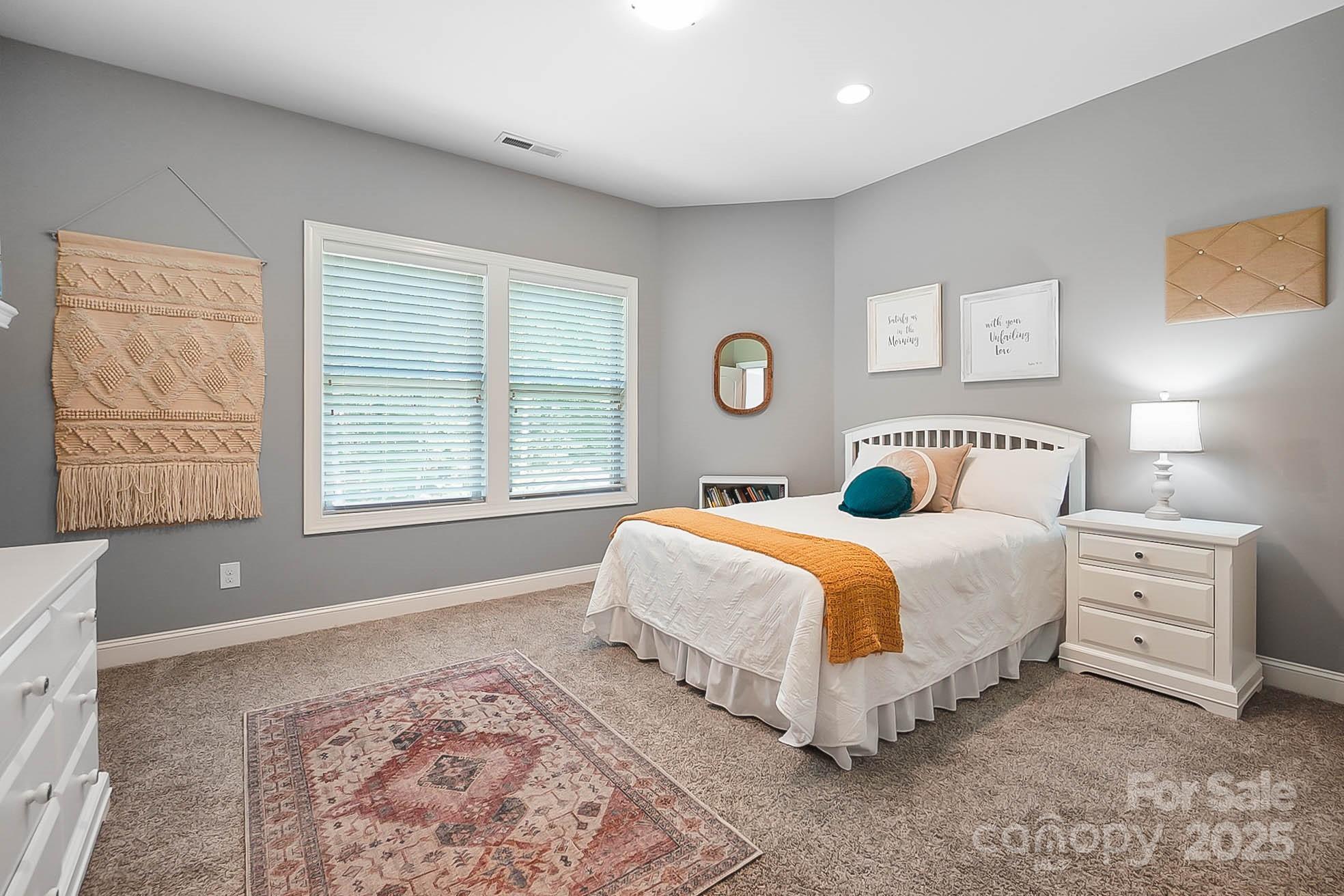 7219 Indian Trail Fairview Road Indian Trail, NC 28079 - Photo 37 of 48 a bedroom with a bed and a lamp