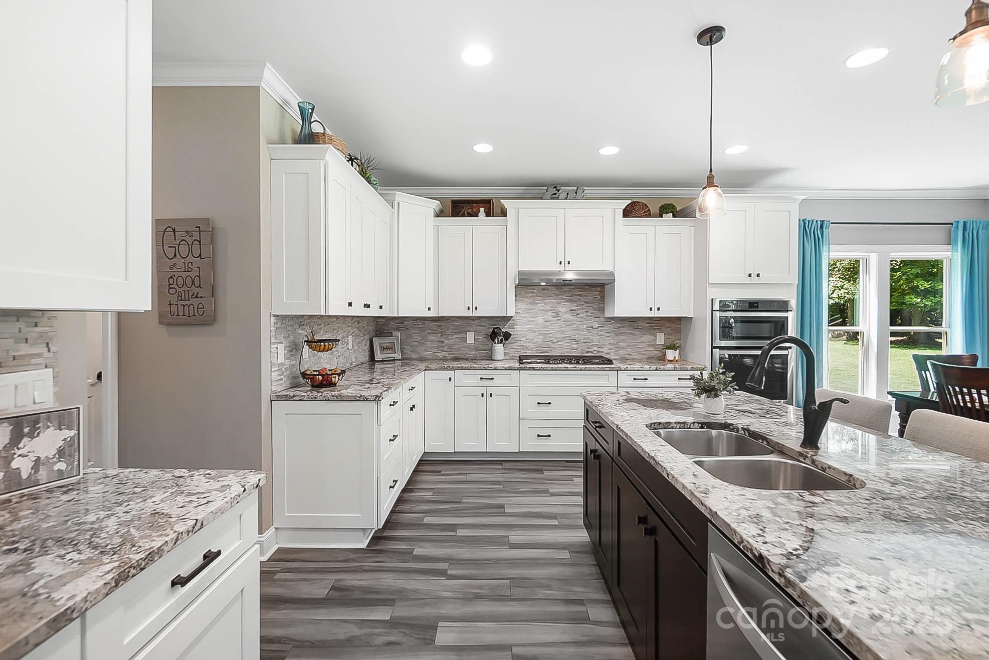 7219 Indian Trail Fairview Road Indian Trail, NC 28079 - Photo 4 of 48 a kitchen with a sink stove and cabinets