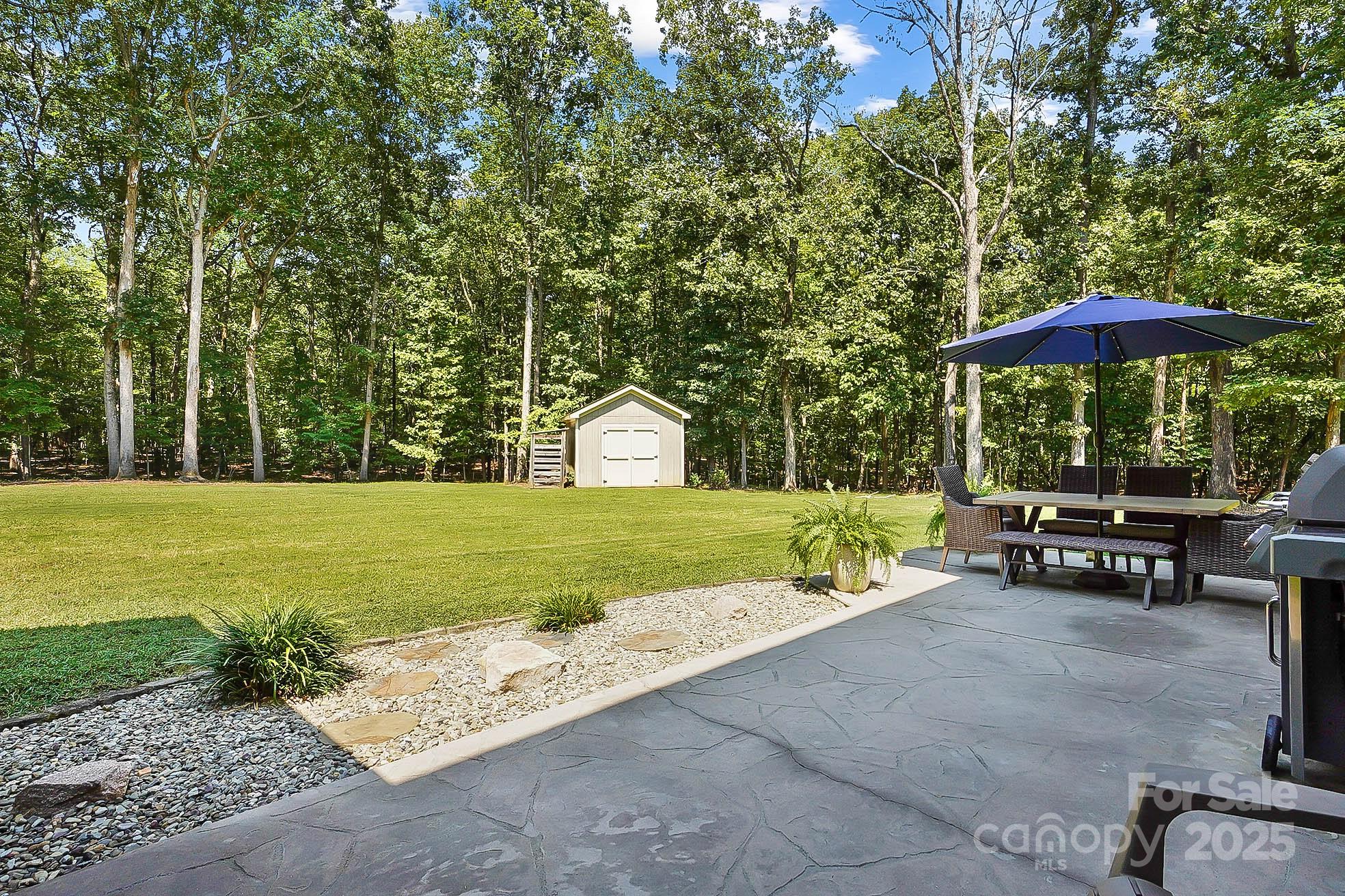 7219 Indian Trail Fairview Road Indian Trail, NC 28079 - Photo 43 of 48 a view of a park with lawn chairs under an umbrella