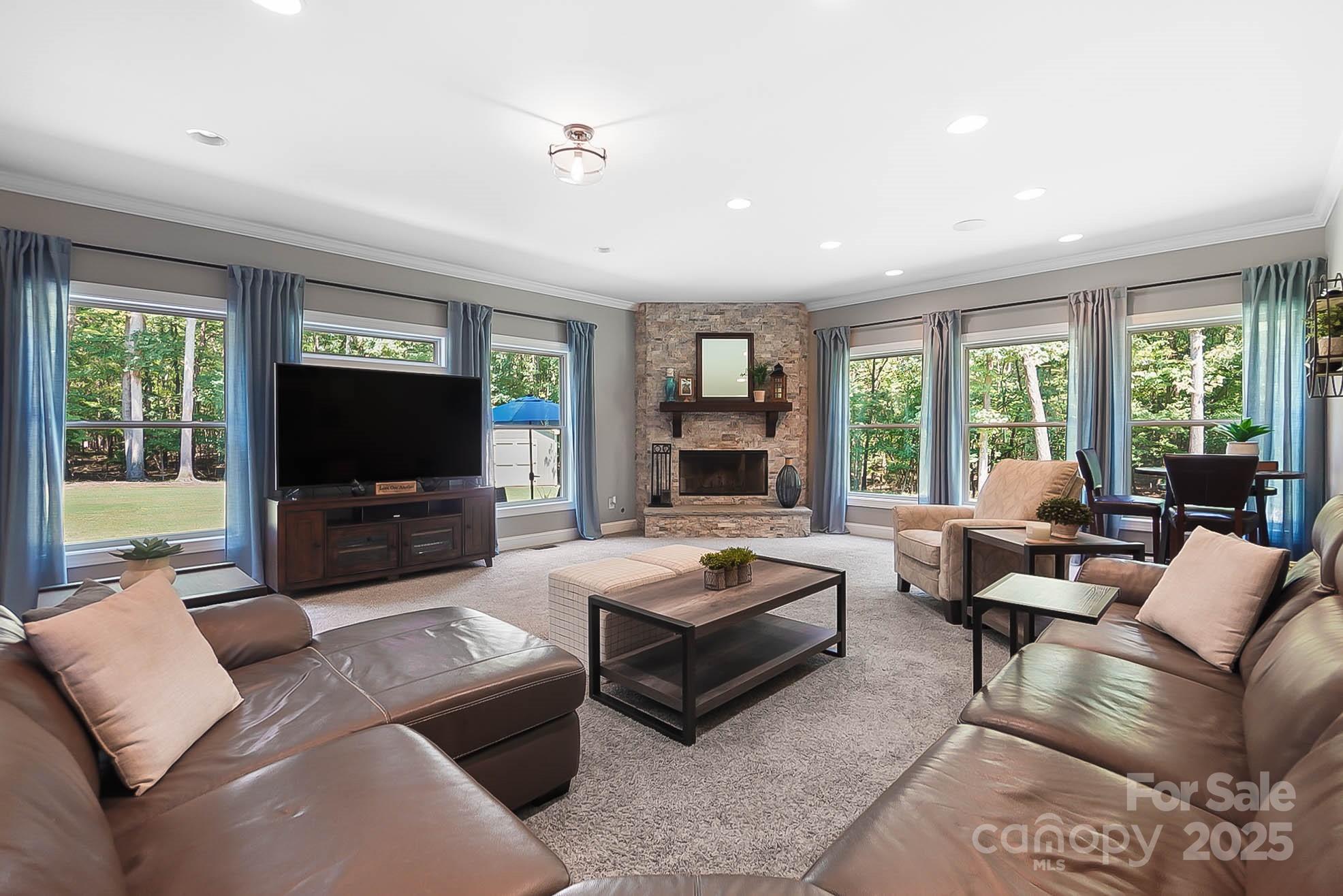 7219 Indian Trail Fairview Road Indian Trail, NC 28079 - Photo 6 of 48 a living room with furniture a flat screen tv and a large window