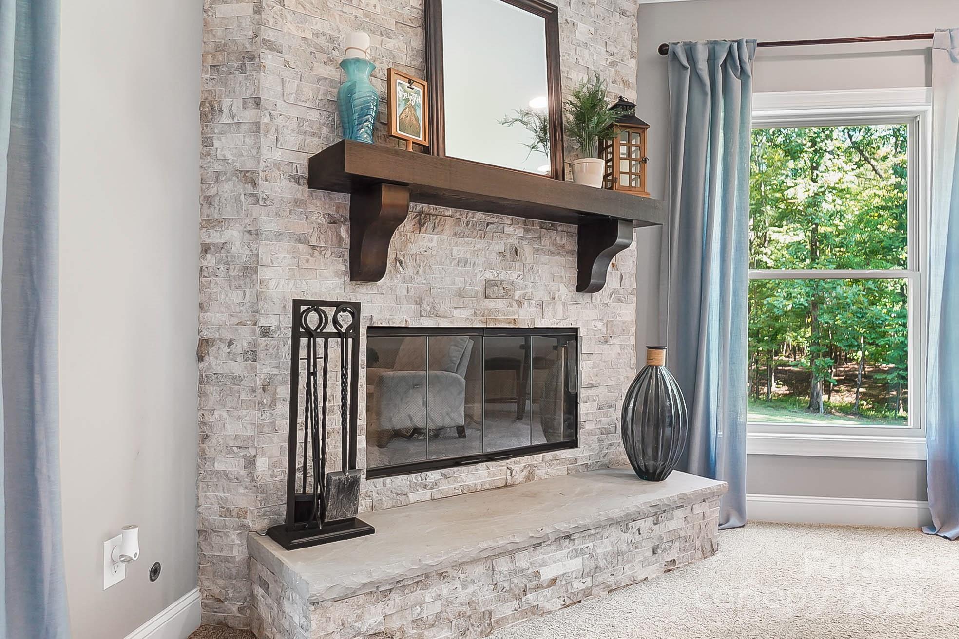 7219 Indian Trail Fairview Road Indian Trail, NC 28079 - Photo 7 of 48 a bedroom with a fireplace and a window