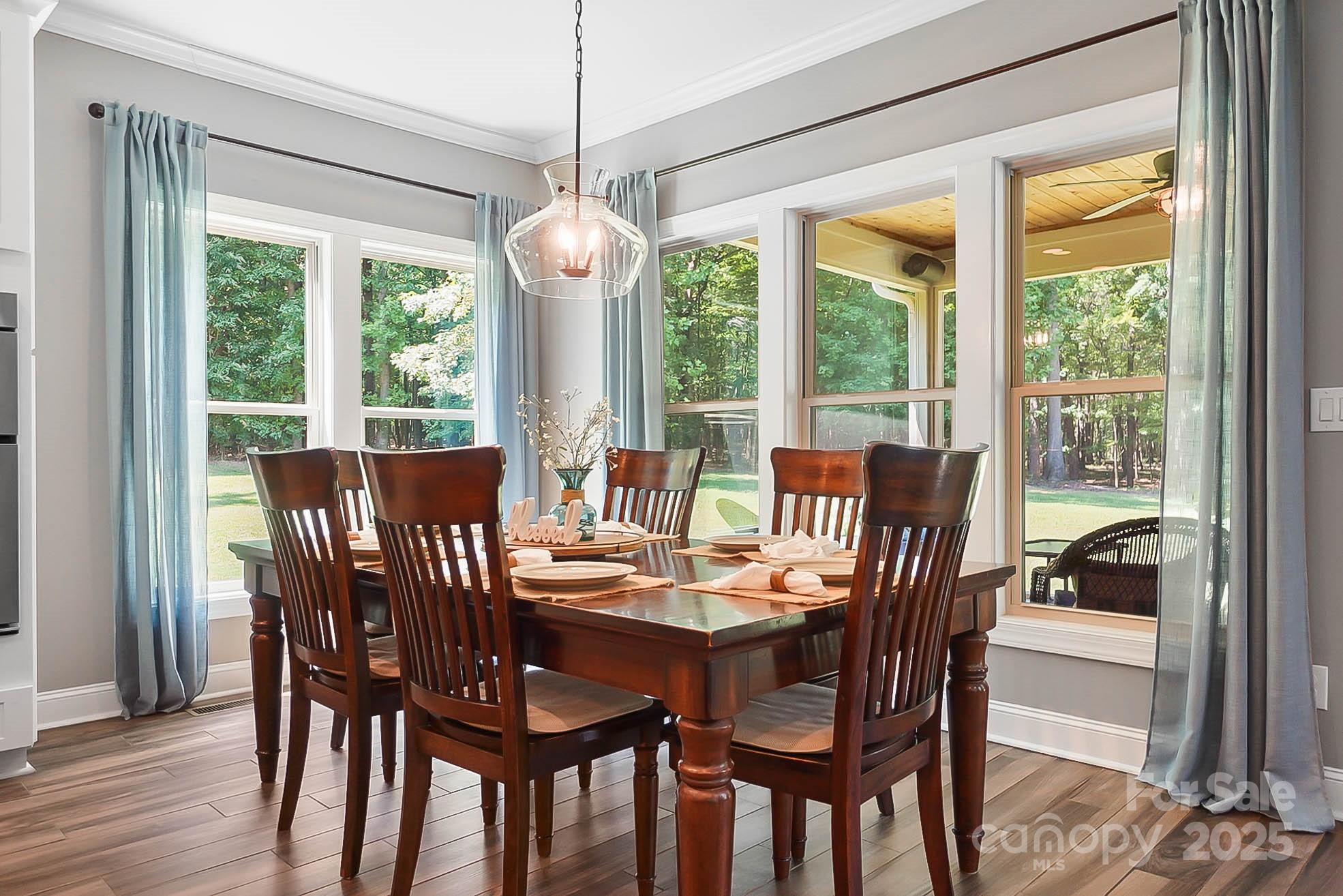 7219 Indian Trail Fairview Road Indian Trail, NC 28079 - Photo 8 of 48 a view of a dining room with furniture window and wooden floor