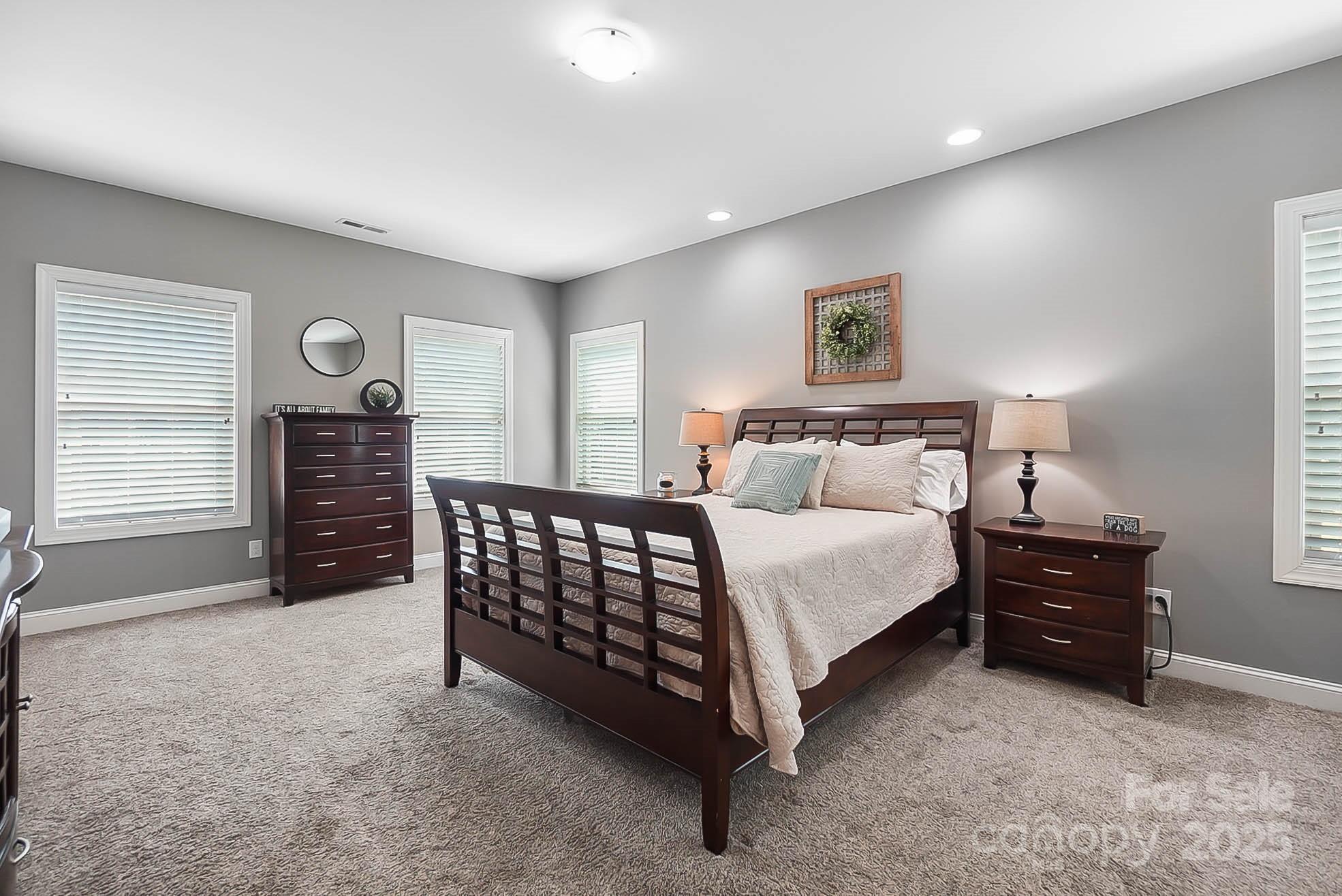 7219 Indian Trail Fairview Road Indian Trail, NC 28079 - Photo 9 of 48 a bedroom with a bed and a night stand