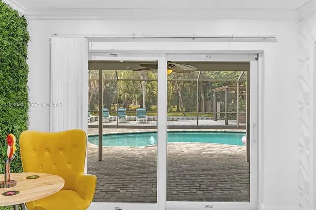 a kitchen with kitchen island white cabinets and refrigerator