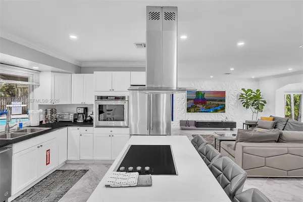 a kitchen with a stove and white cabinets