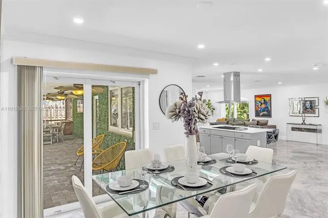 a view of a patio with a table chairs and wooden floor