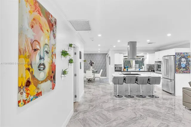 a kitchen with granite countertop a sink a counter top space appliances and cabinets