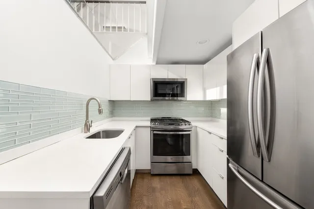 a bathroom with a granite countertop sink a shower and mirror