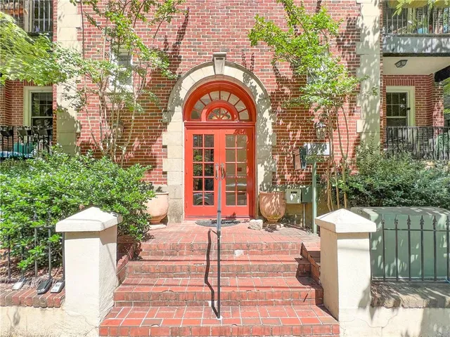 a front view of a house with a garden
