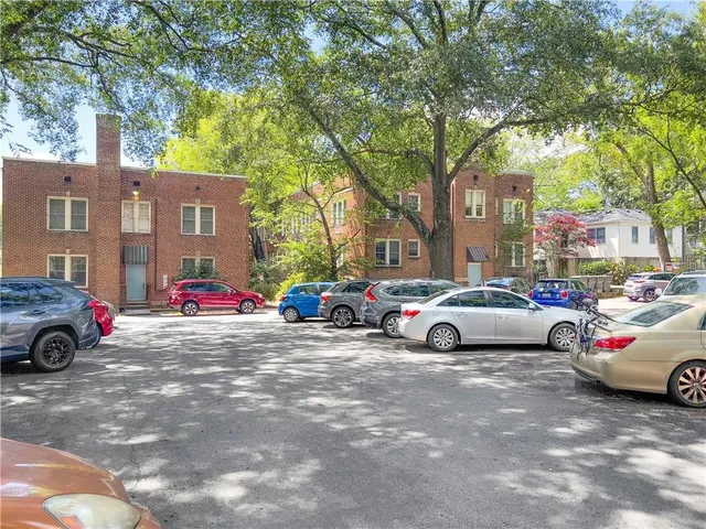 a view of cars parked in front of a house