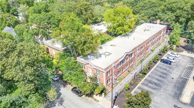 an aerial view of a house with a yard and deck