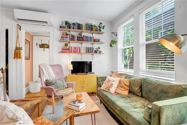 a living room with furniture fireplace and a large window
