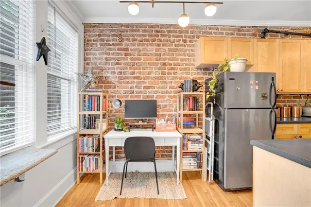 a workspace with furniture window and wooden floor
