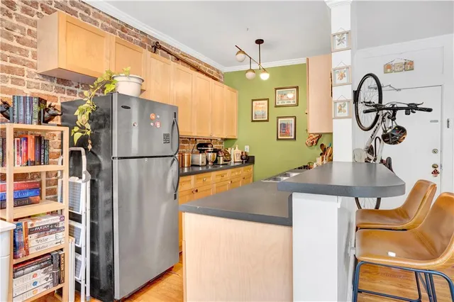 a kitchen with stainless steel appliances granite countertop a sink and a refrigerator