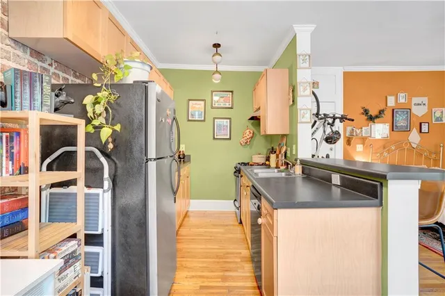 a kitchen with stainless steel appliances granite countertop a sink and a refrigerator