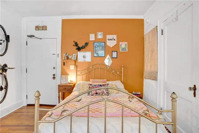 a view of a bedroom with mirror and door