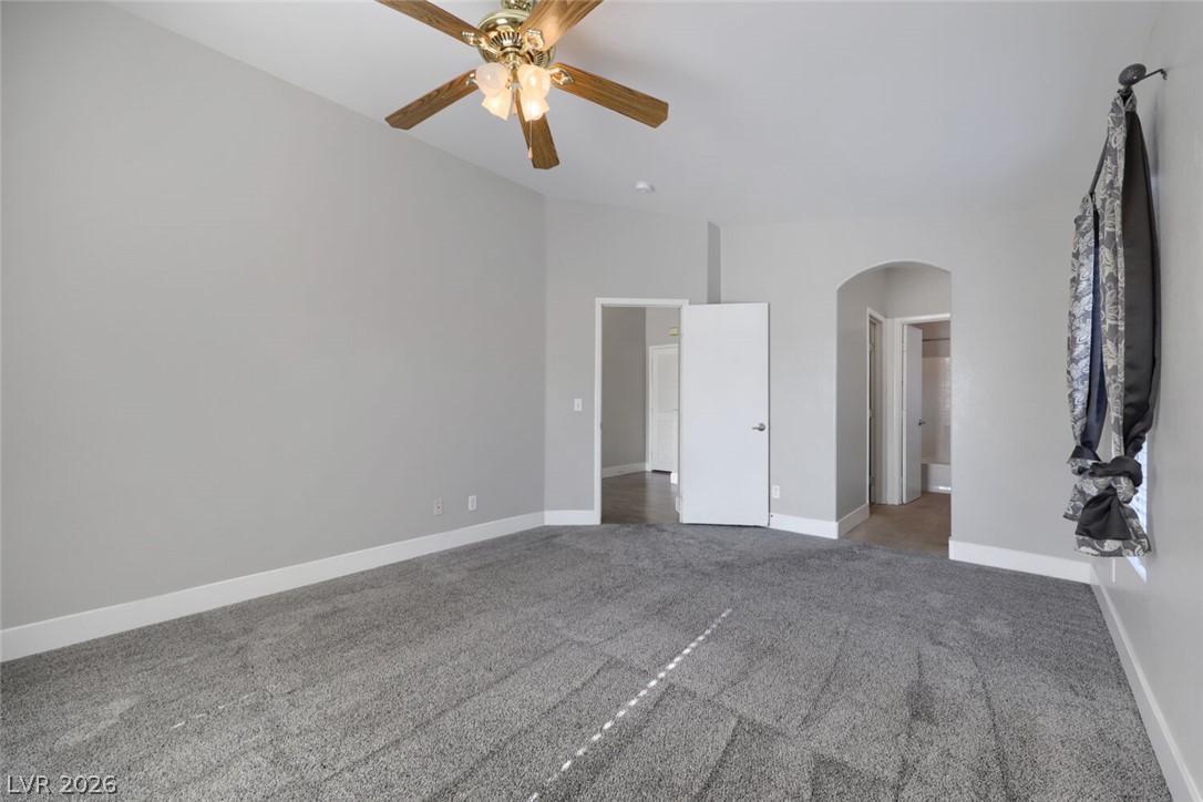 5985 High Steed Street, Unit 101 Henderson, NV 89011 - Photo 17 of 38 A spacious, neutral-toned bedroom awaits your personal touch with soft carpeting and ceiling fan for comfort.