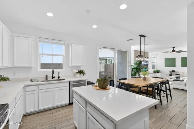 a kitchen with a table chairs and refrigerator