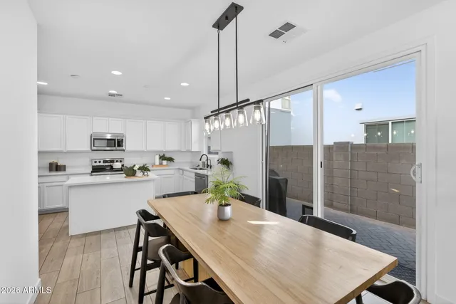 a kitchen with a sink a stove and chairs